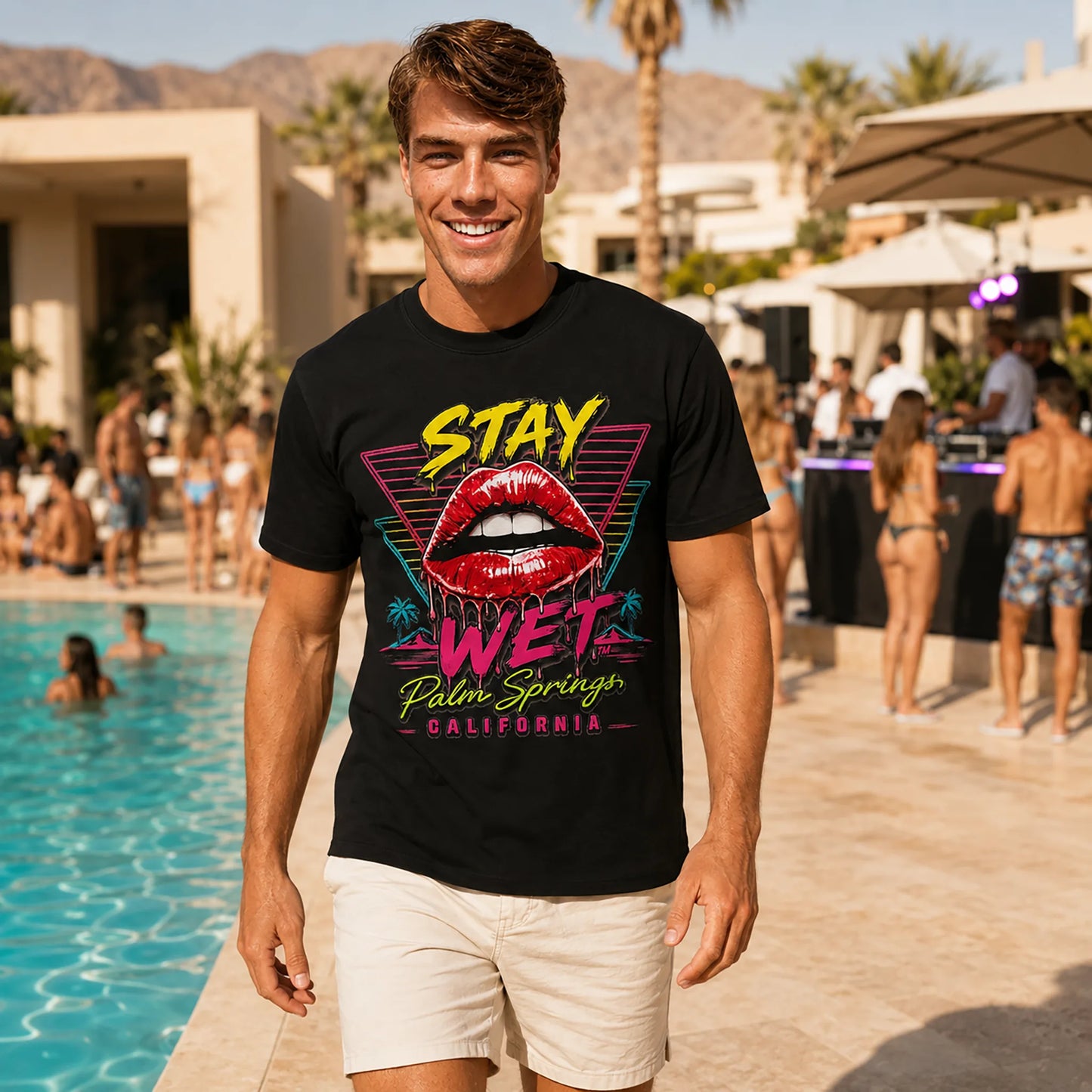 Luca wearing the black Stay Wet Hot Lips and Triangles tee at a Palm Springs resort pool party