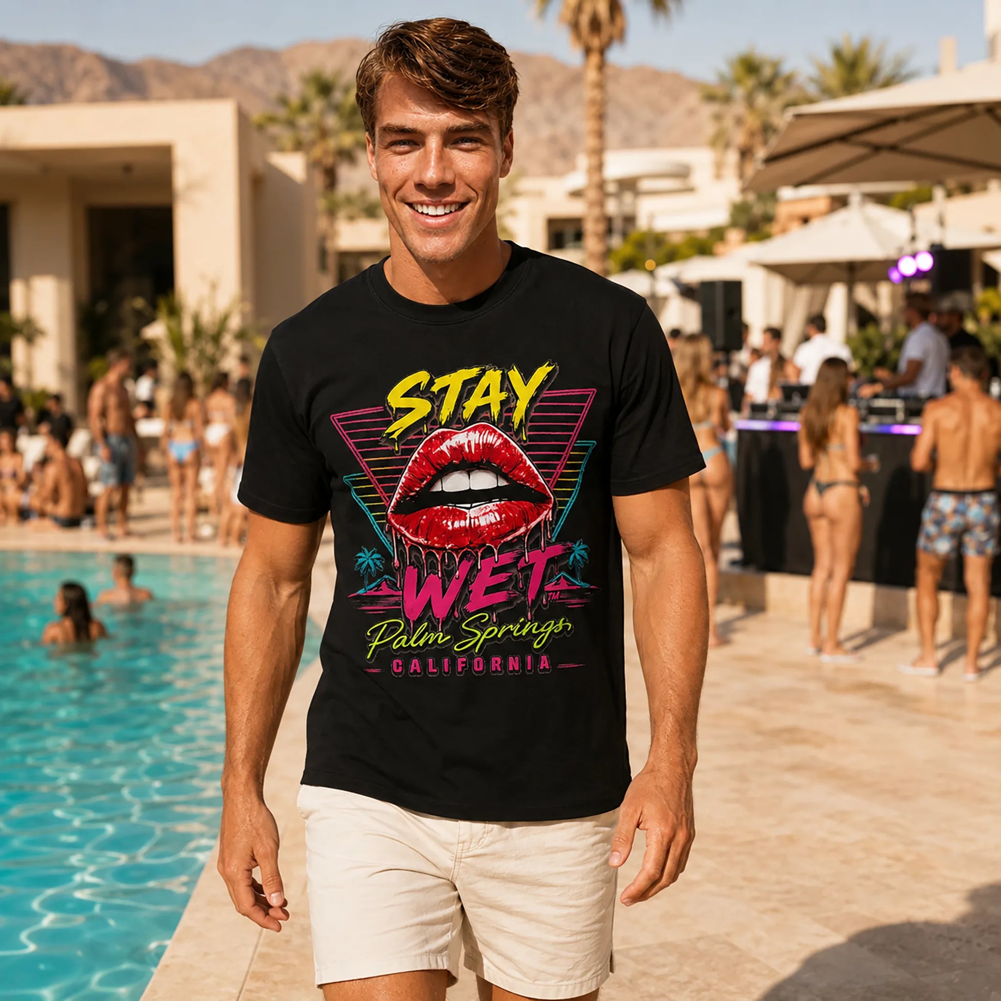 Luca wearing the black Stay Wet Hot Lips and Triangles tee at a Palm Springs resort pool party