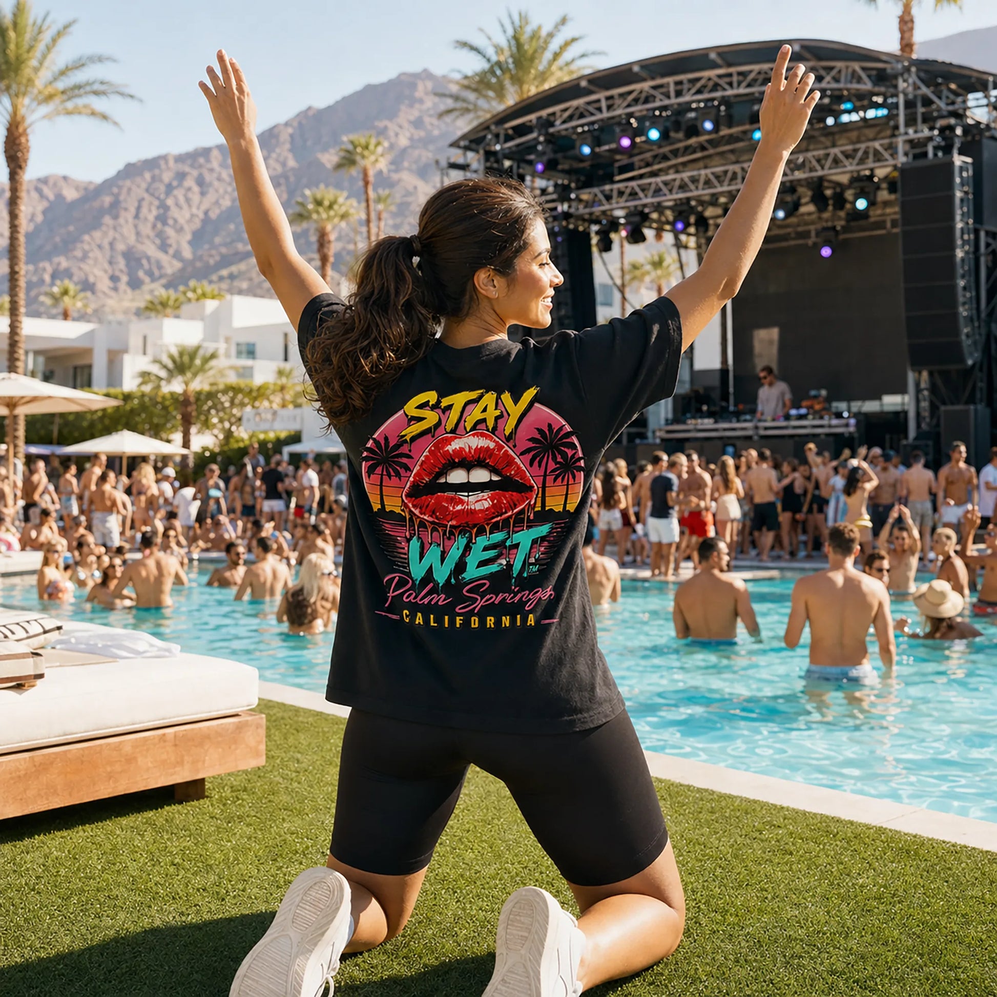 Jasmine wearing the black Stay Wet Hot Lips at Sunset back-print tee at a Palm Springs pool party