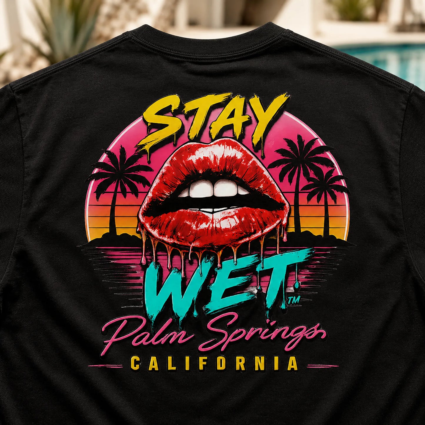 Close-up of the Hot Lips at Sunset graphic printed on a black Stay Wet tee