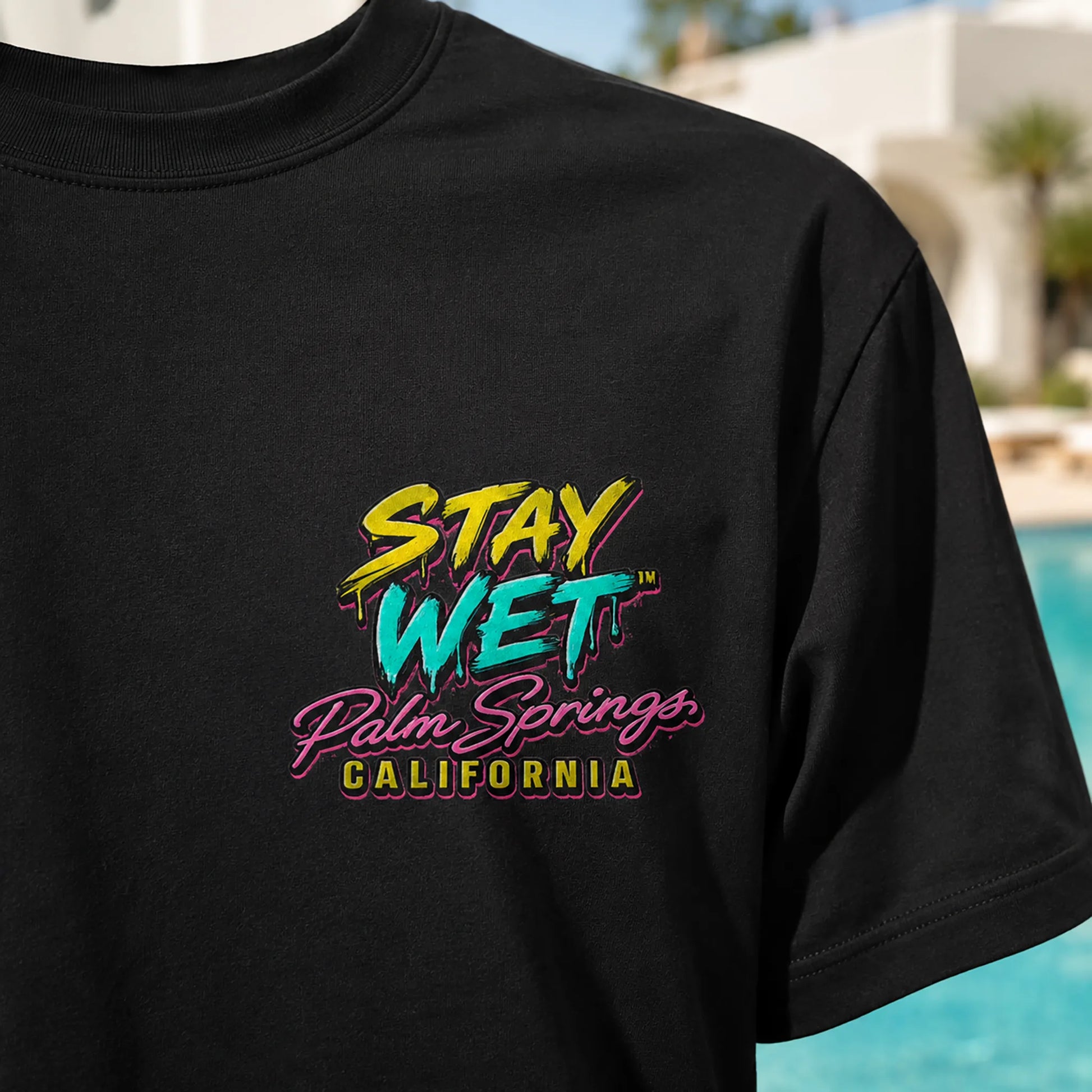 Close-up of the Hot Lips at Sunset graphic printed on a black Stay Wet tee
