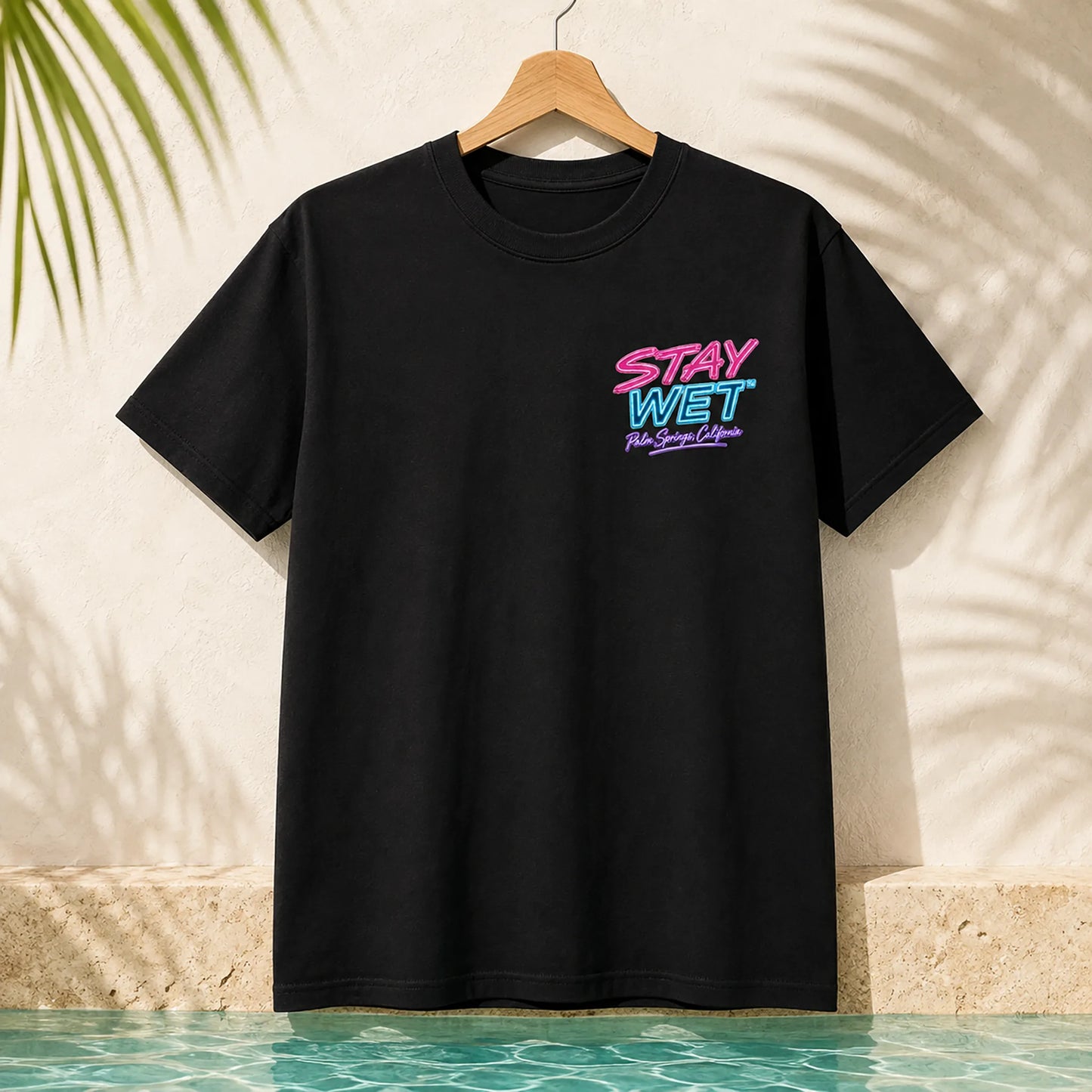 Black Stay Wet Poolside Takeover Pink Flamingo front and back tee mockup showing the small left-chest print