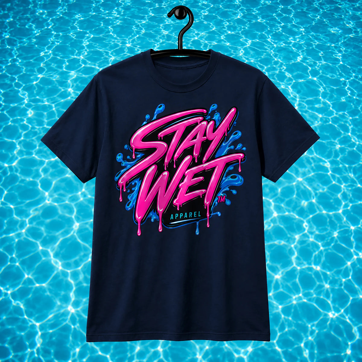 Navy Stay Wet Signature Tee with large pink-and-blue front logo on a bright swimming-pool water background.